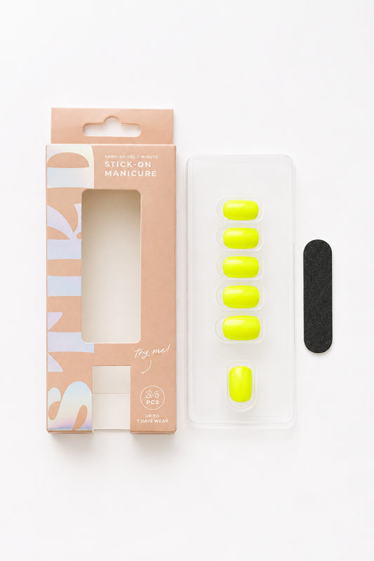 Citron neon yellow press-on nails by STIKD, box opened with nail tray and mini file
