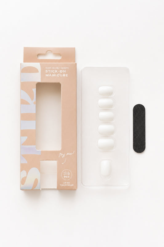 Magnolia white press-on nails by STIKD, box opened with nail tray and mini file