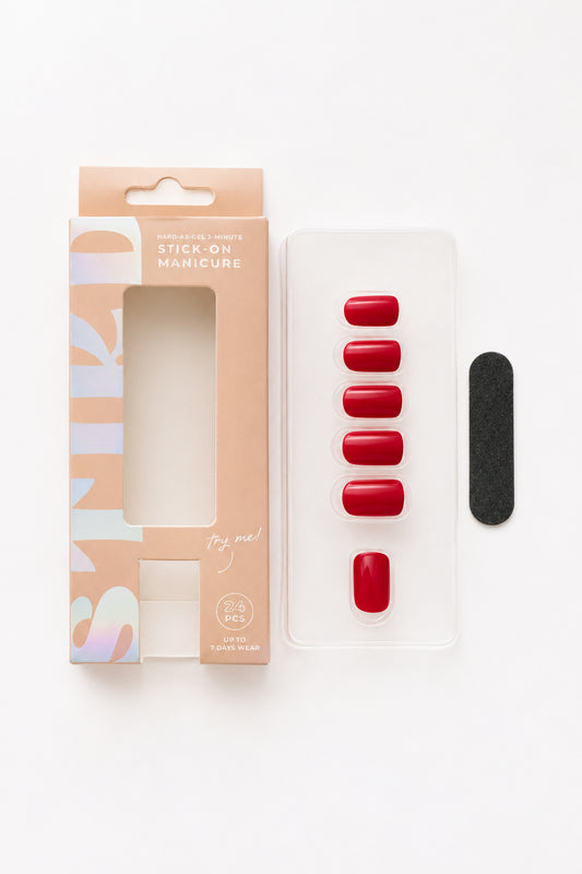 Poppy deep red press-on nails by STIKD, box opened with nail tray and mini file