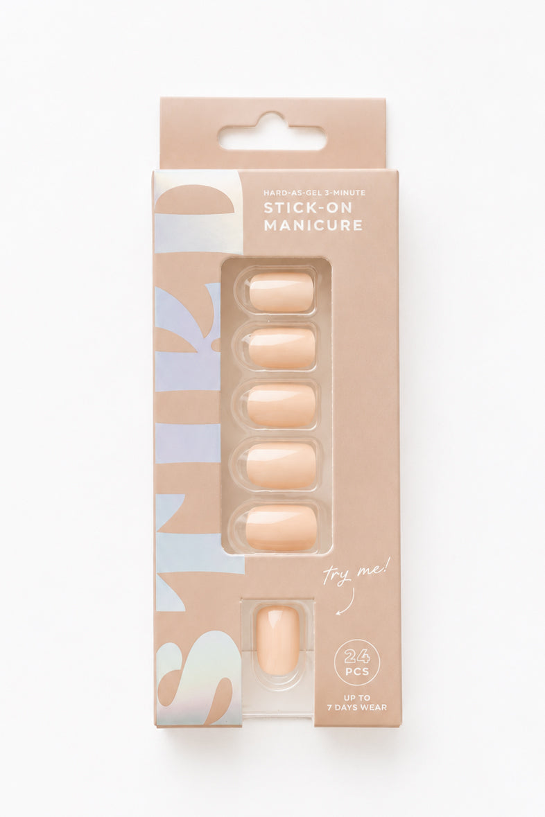 Apricot peach nude short press-on nails by STIKD in retail box