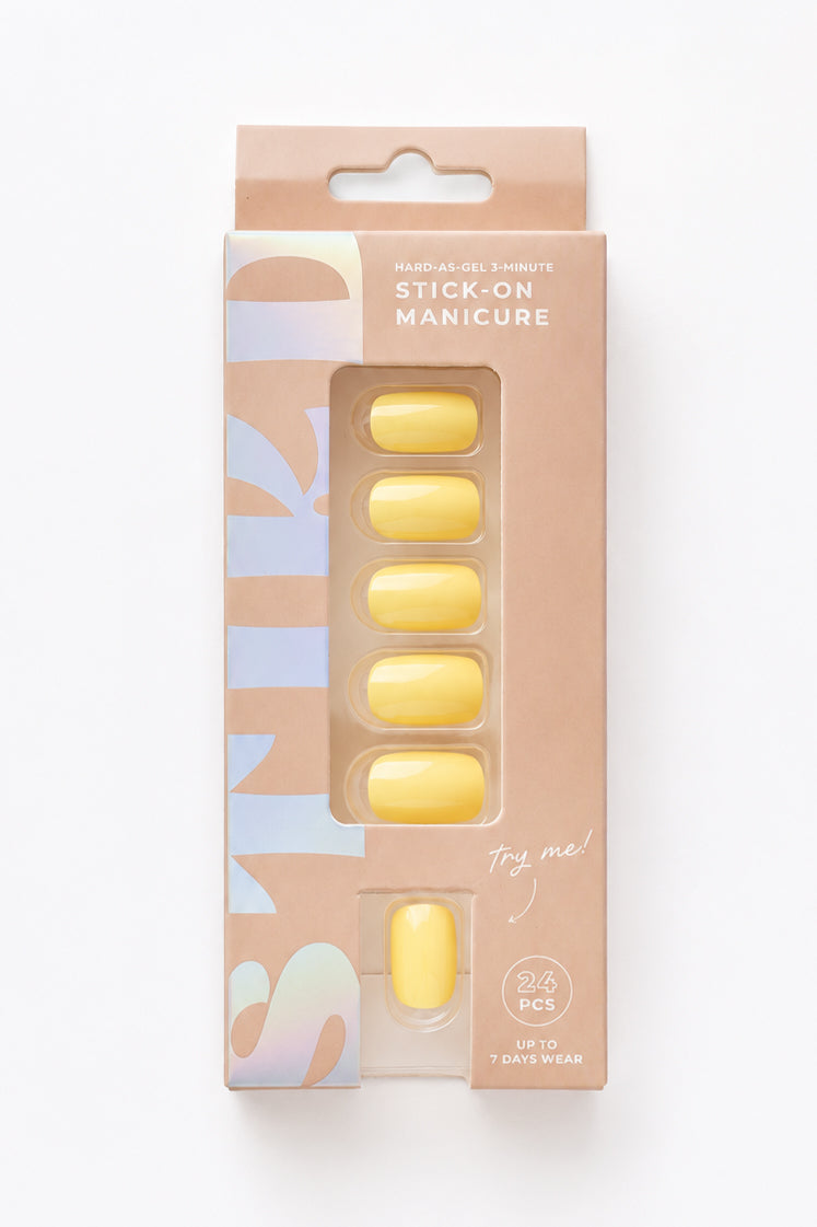 Buttercup pastel yellow short press-on nails by STIKD in retail box